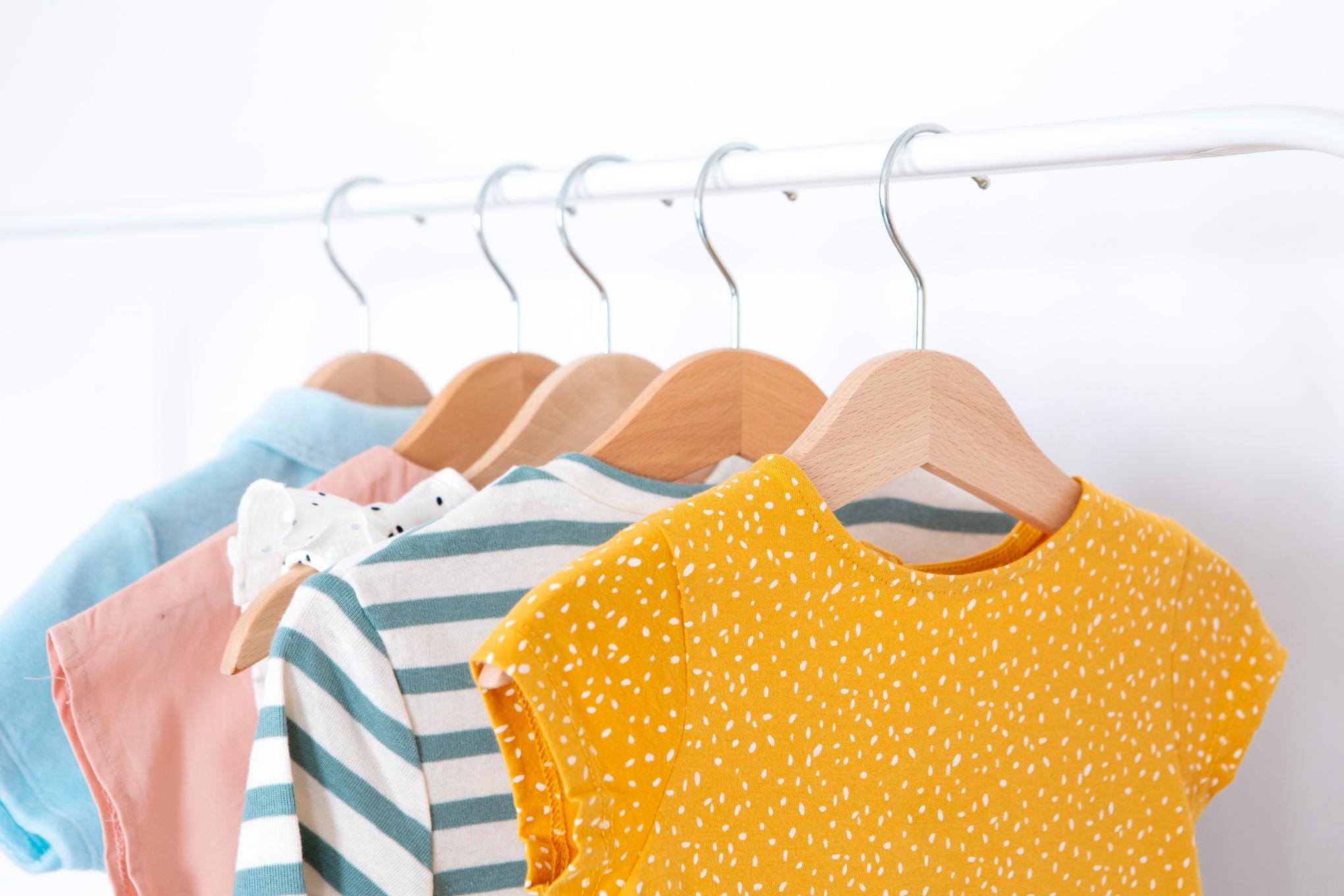 Children's clothing organized on racks in our clothing closet